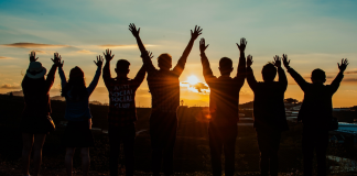 5 Easy Ways To Give A Positive Morning Start Person stretching and smiling to start a positive morning routine